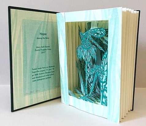 handmade book with paper cutout designs