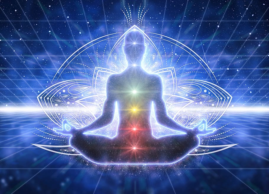 illustration of seated person with hands on knees, colored chakras running up their body